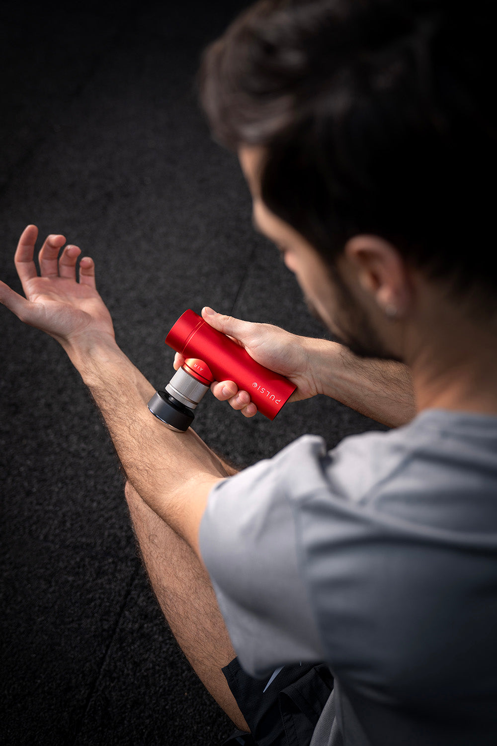 A gray and white pod with a long adhesive patch, viewed from the side.