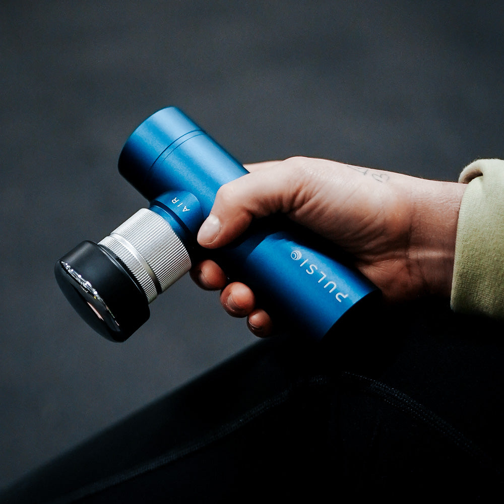 White device in an open box labeled 'Pulse Tens Pod' with icons on the lid.